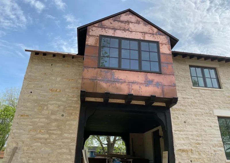 Copper metal panel facade on a stone building for Roof Repair in Santa Fe